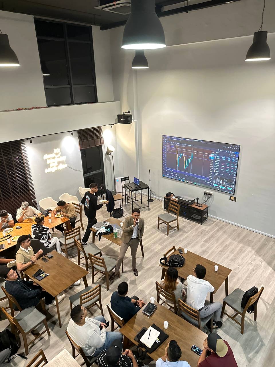 PounderFX group mentorship session with students gathered around tables in a classroom setting.